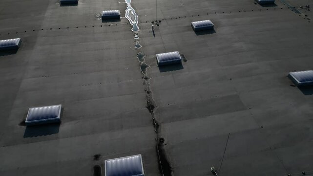 A lightning conductor is used to protect buildings from lightning that can damage a house or its electrical equipment is routed to the highest points of a green garden roof.