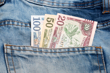 Old Trinidad and Tobago dollar in the pocket of blue jeans