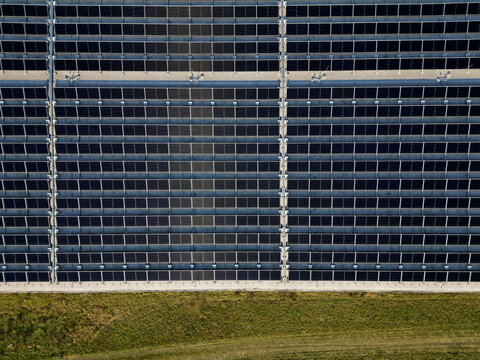extensive roof of industrial and logistic hall are gradually being filled with solar panels. covering roofs helps industrial developer increase energy efficiency and sustainability site, building 