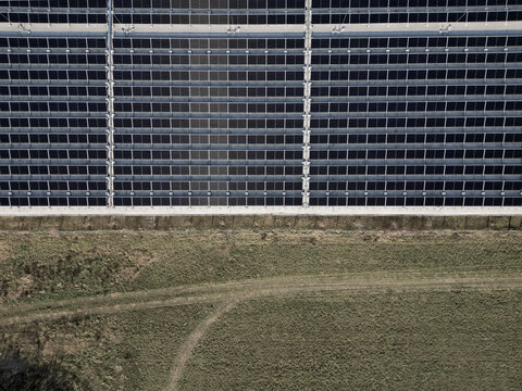 extensive roof of industrial and logistic hall are gradually being filled with solar panels. covering roofs helps industrial developer increase energy efficiency and sustainability site, building 