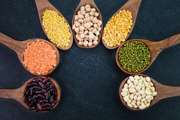 Closeup view of pulses and lentils on a black background.