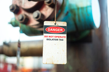 Isolation tag or lockout tagout which is hanged on pipeline valve that under maintenance, do not...