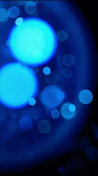 Abstract blue bokeh background with soft glowing circles creating a dreamy atmosphere