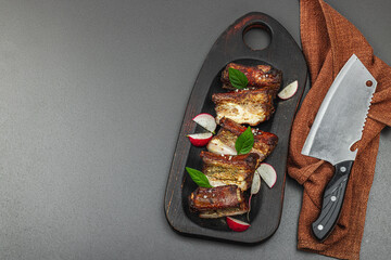 Baked pork ribs with spices, vegetables and sauce. Traditional ingredient for BBQ, picnic concept