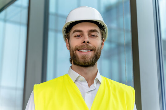 Waist up picture pf a you ng engineer in a hard cap