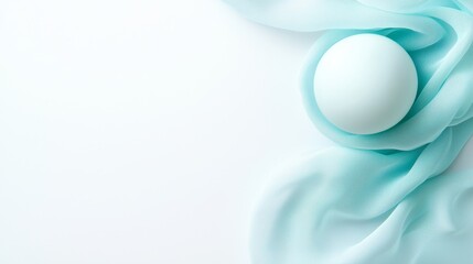 A white egg sitting on top of a blue cloth