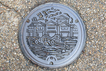 Japanese manhole cover on the street of Funaya Japan