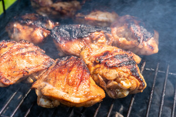 A plate of chicken is being cooked on a grill