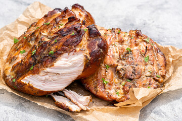 A piece of meat is cut in half and is sitting on a paper plate