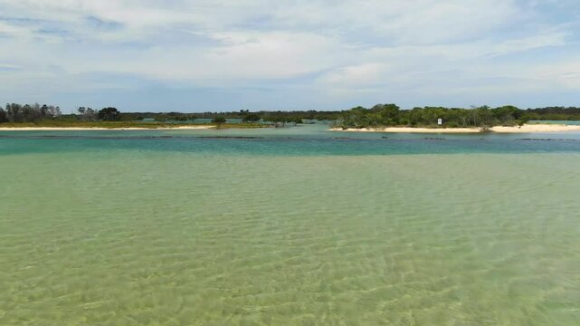 Bellinger River, shallow waters, Urunga, New South Wales, Australia. Aerial forward, low flight, copy space