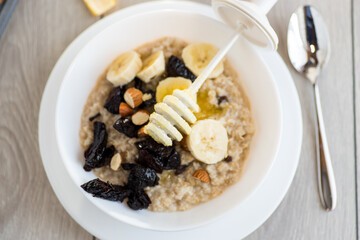 Healthy and nutritious breakfast with oatmeal and honey