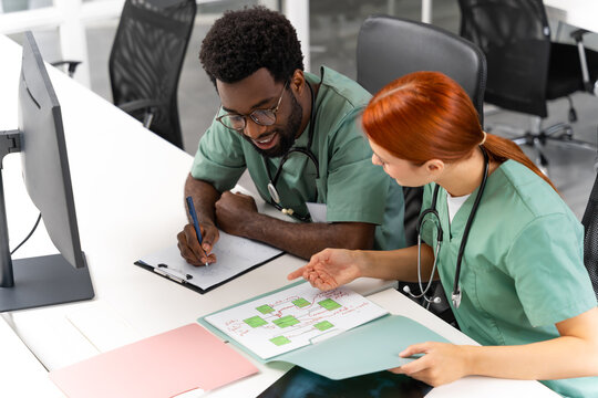 Multiethnic group of healthcare professionals working together in clinic sharing expertise