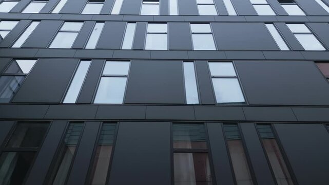 Narrow rectangle glass windows in tall elegant office block building New theatre Pilsen