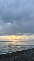 Obraz premium Sunset overlooking the Black Sea from a pebble beach in Abkhazia