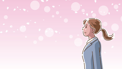 桜が風に舞う中で佇むスーツ姿の女性の横顔