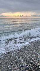 Fototapeta premium Sunset overlooking the Black Sea from a pebble beach in Abkhazia