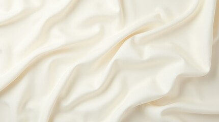 Fototapeta premium Smooth Cream Fabric Drapes Elegantly on a Soft Surface With Gentle Folds and Texture