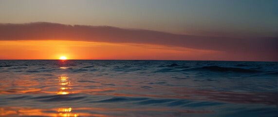 Obraz premium Exquisite closeup of a calm sea reflecting colorful sunsets inviting blissful moments spent lounging under the fading light