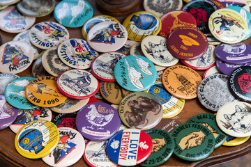 A  a collection of pin-back buttons, also known as pin buttons, button badges, or simply pins or...