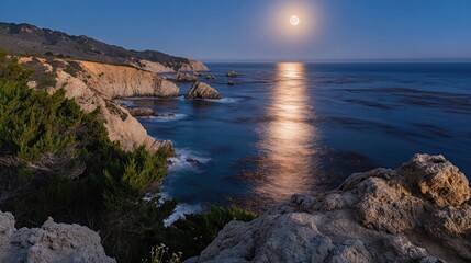 Full moon over dramatic coastal cliffs and ocean.