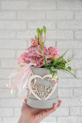 Hand Holding Floral Gift With Heart Shaped Mother's Day Decoration. Polish Mother's day. Kocham Cię Mamo. Dzień Matki © AFilipczuk