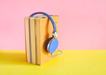 audio book with row of books and vintage headphone.Podcasting,literature...