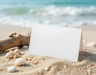 Summer-themed business card mockup on a sandy beach with seashells and a blurred ocean background, perfect for travel or tourism branding.