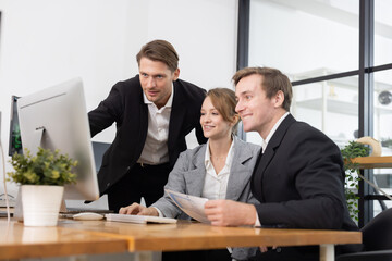 Colleagues collaborating on a project in a modern office