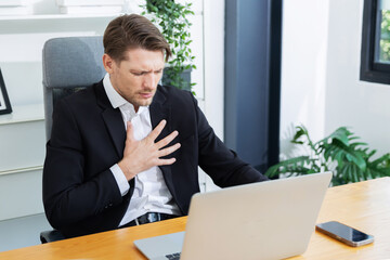 Caucasian businessman grab his chest with pain from heart attack