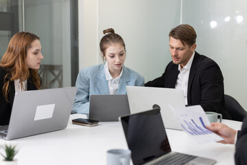 Fototapeta premium Colleagues collaborating on a project in a modern office