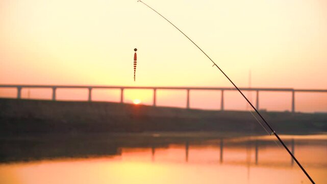 Fishing bait for fishing with pinning rod at sunset. Silicone bait on a double hook