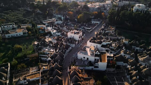 Flight over the center of Alberobello. The city is famous for the amazing architecture of the Truli houses. Alberobello is visited by millions of tourists a year. Sunset over Truli.