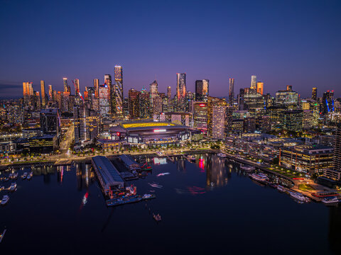 Melbourne, Australia &ndash; February 2, 2025: A stunning view of Marvel Stadium and Docklands Harbour at sunset, with the modern stadium framed by the vibrant cityscape and calm waters of the harbour.