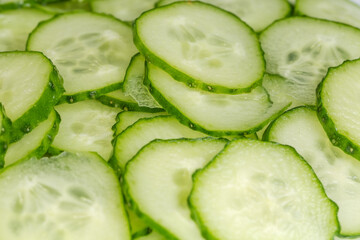 Fresh cucumbers cut into circles, side view close-up