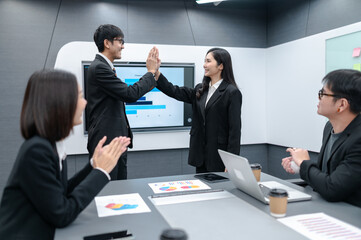 Business people, men and women, high five, meeting in office with documents, laptop, planning sales, digital marketing and growth strategies, analysis with colorful charts and graphs.
