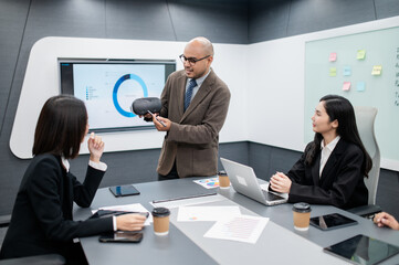 Male software developer, VR glasses system meeting in office with documents, laptop, sales planning, digital marketing and growth strategies, analysis with colorful charts and graphs.