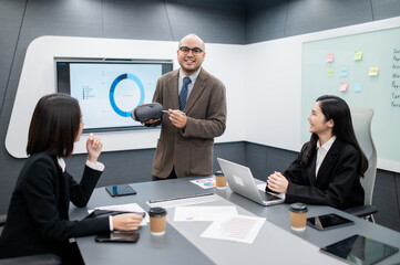 Male software developer, VR glasses system meeting in office with documents, laptop, sales planning, digital marketing and growth strategies, analysis with colorful charts and graphs.