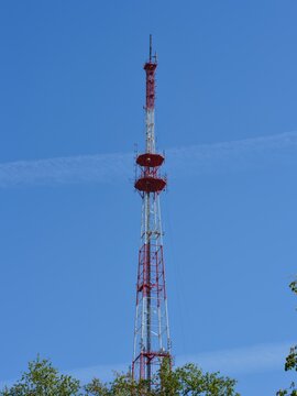 High television tower against a blue sky