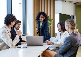 Fototapeta premium African woman sale manager is showing annual report chart to her colleagues in the executive meeting for next year plan with market share increase for global business and investment concept