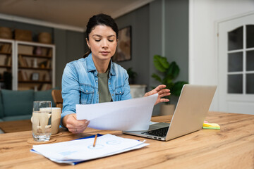 Young confident businesswoman working at home office on laptop computer. Business owner...