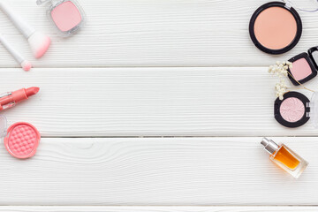 Makeup accessories - brushes and pink pastel cosmetic products, flat lay, top view