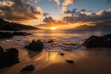 Sunset over the ocean with rocky shore and clouds on Maui's coastline