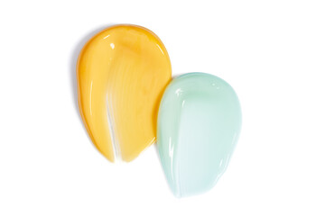 Two smooth, glossy cosmetic smears isolated on white background ideal for showcasing skincare products texture