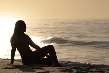 Girl silhouette on beach at dawn 3.1