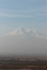 Majestic snow-capped mountain in mist.