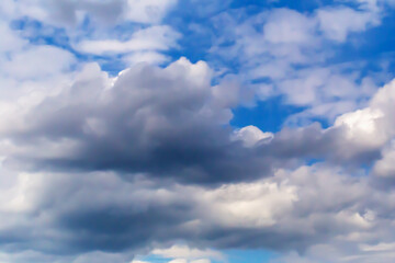 Fototapeta premium Cloud formations captivating imagination with their shapes against vivid blue sky. Clouds create dynamic patterns, showcasing nature beauty. Sky evokes calm and serenity. Selective focus, defocus