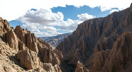 Fototapeta premium Exploring Jagged Cliffs Canyon with Dramatic Sky and Distant Mountain Views