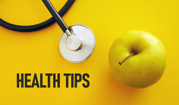 Health Tips, health conceptual. Healthy fresh apple with stethoscope