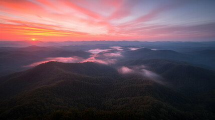 Obraz premium Sunrise over misty mountain range, aerial view (1)
