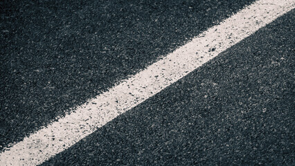 Obraz premium white streak of paint on gray asphalt